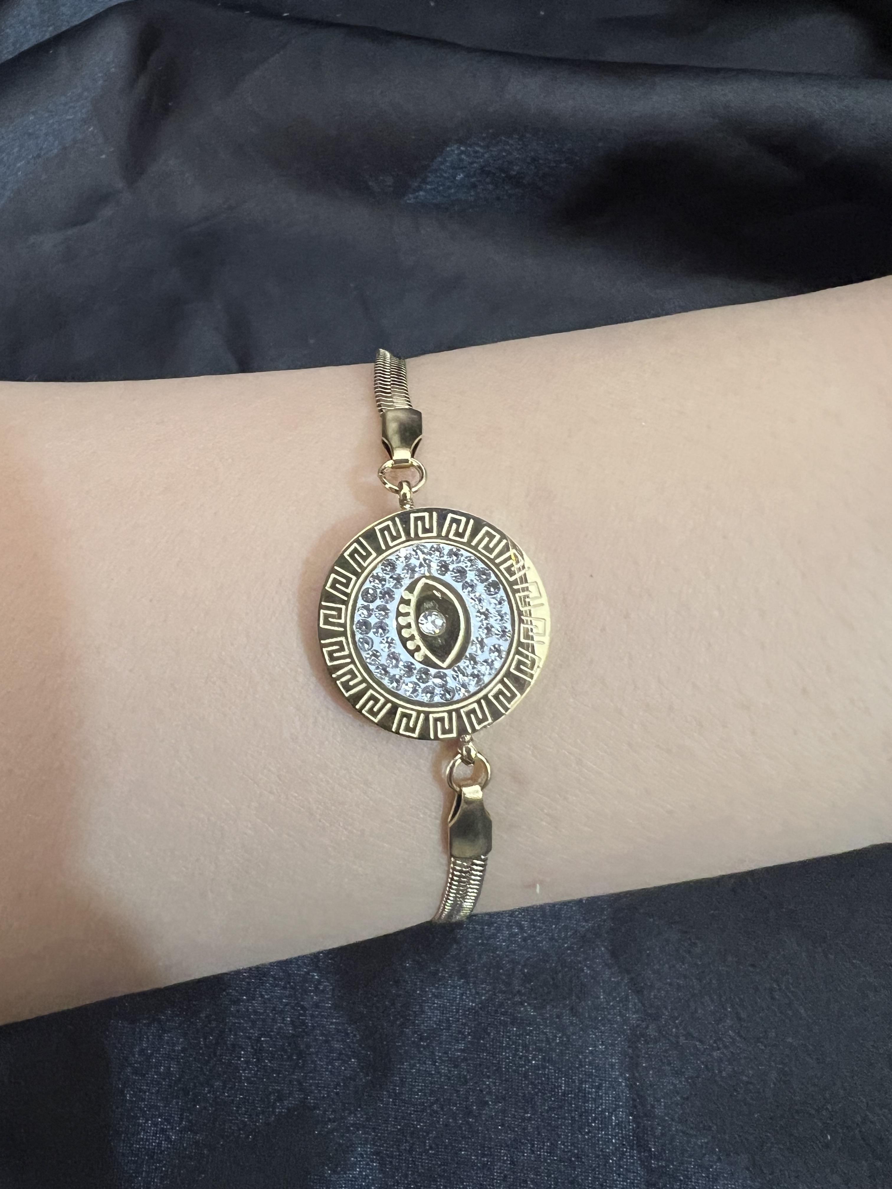 İçi taşlı göz model gold renk çelik bileklik